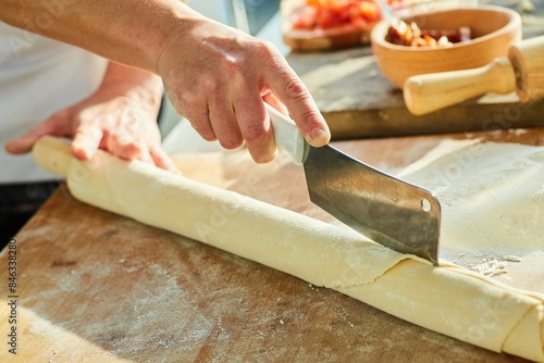 Step-by-step cooking process. Cut the dough into layers to make homemade pasta.