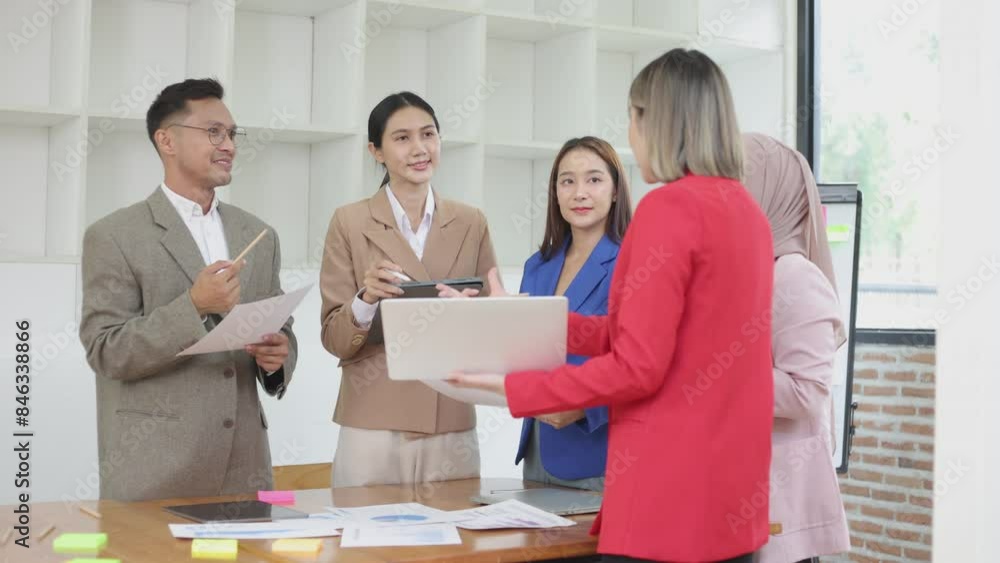 Asian group of people working with documents have financial or marketing charts on a board room table at a business presentation or seminar, business training meeting concept. Asian group of people working with documents have financial or marketing charts on a board room table at a business presentation or seminar, business training meeting concept.