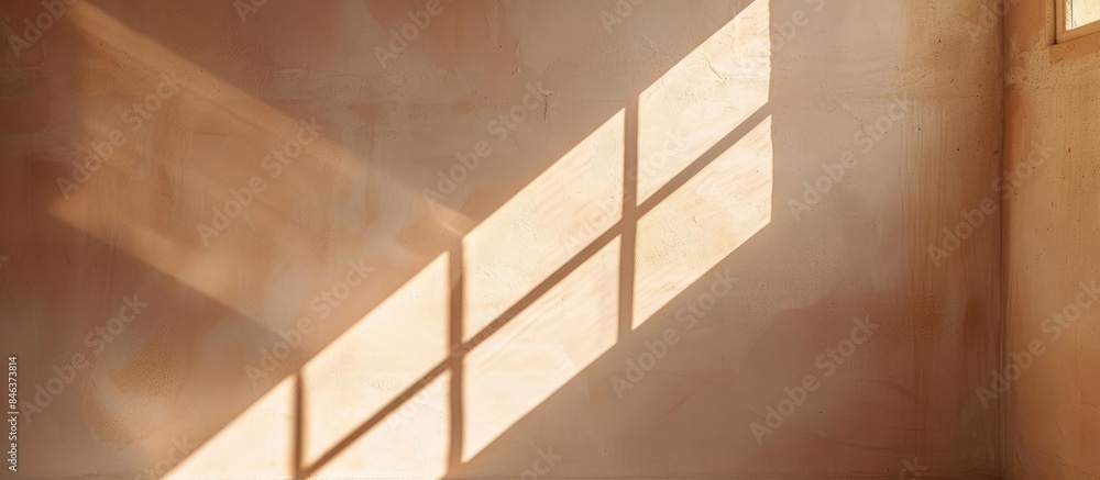 Obraz premium Engaging and Natural Abstract Diagonal Window Shadows and Light on Solid Beige Wall Texture