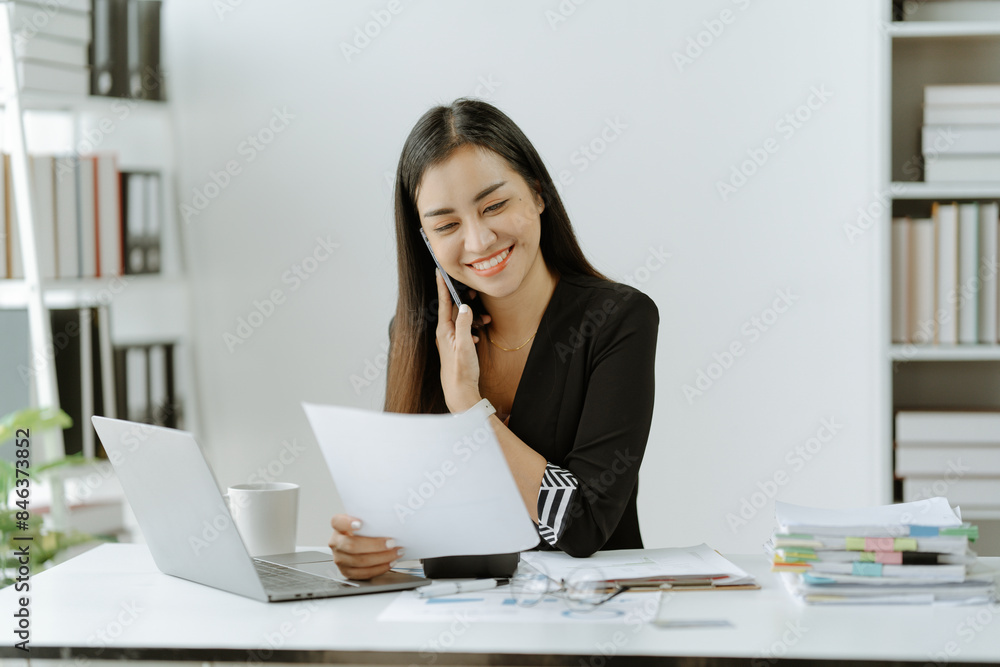 Shot of an Asian young businesswoman working on a laptop computer in her workstation.Portrait of Business people employee freelance online marketing Shot of an Asian young businesswoman working on a laptop computer in her workstation.Portrait of Business people employee freelance online marketing