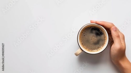 A Hand Holding a Cup of Coffee photo