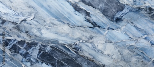 An abstract panorama of a natural stone texture in shades of blue black gray and white resembling a marble or granite surface Copy space image © StockKing