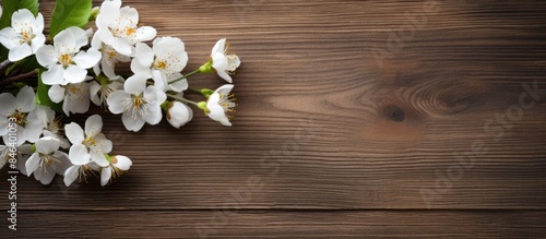 A spring themed copy space image showcasing beautiful white flowers placed on a rustic wooden background ideal for Mother s Day or Easter designs © StockKing