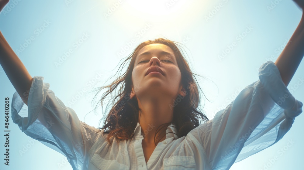 Naklejka premium Portrait of a Determined Woman Raising Her Arms Up Towards the Sky in a Gesture of Triumph