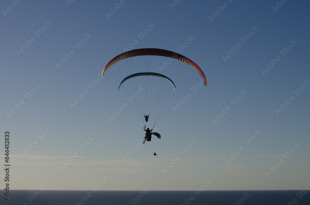 Sunset over the sea in Basque country with people doing paragliding
Sunset over the sea in Basque country with people doing paragliding