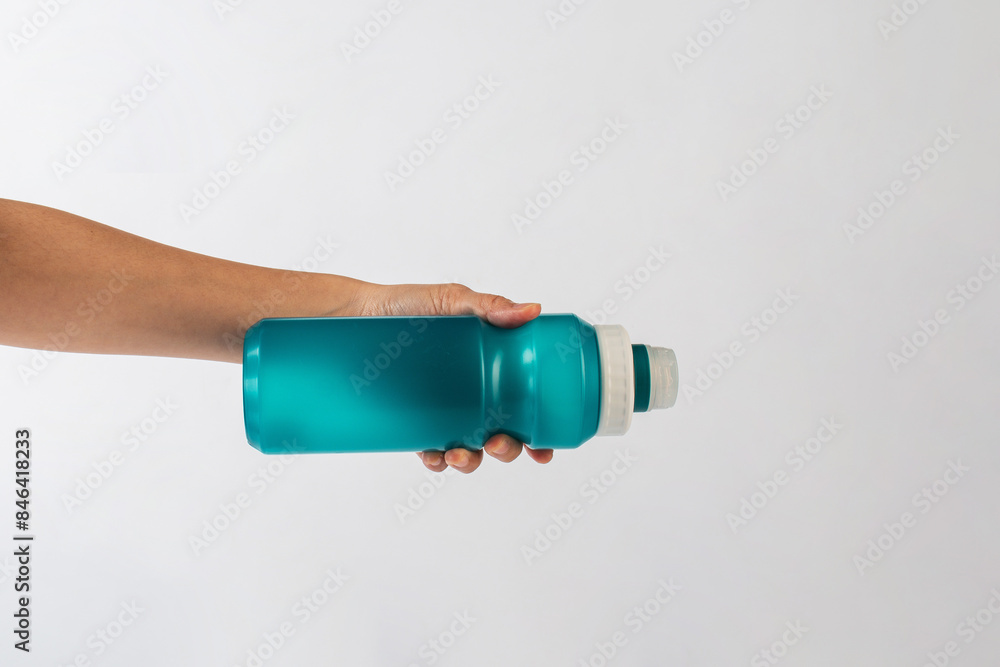 Colourful bottle tumbler and hand isolated on white bakcground Colourful bottle tumbler and hand isolated on white bakcground