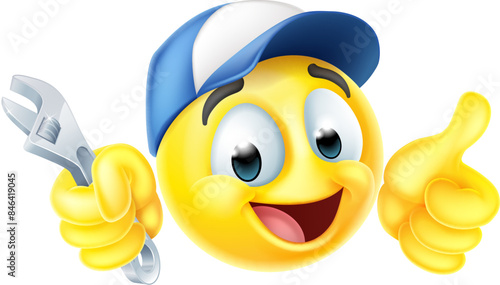 A mechanic or plumber holding a spanner or wrench emoticon face emoji icon