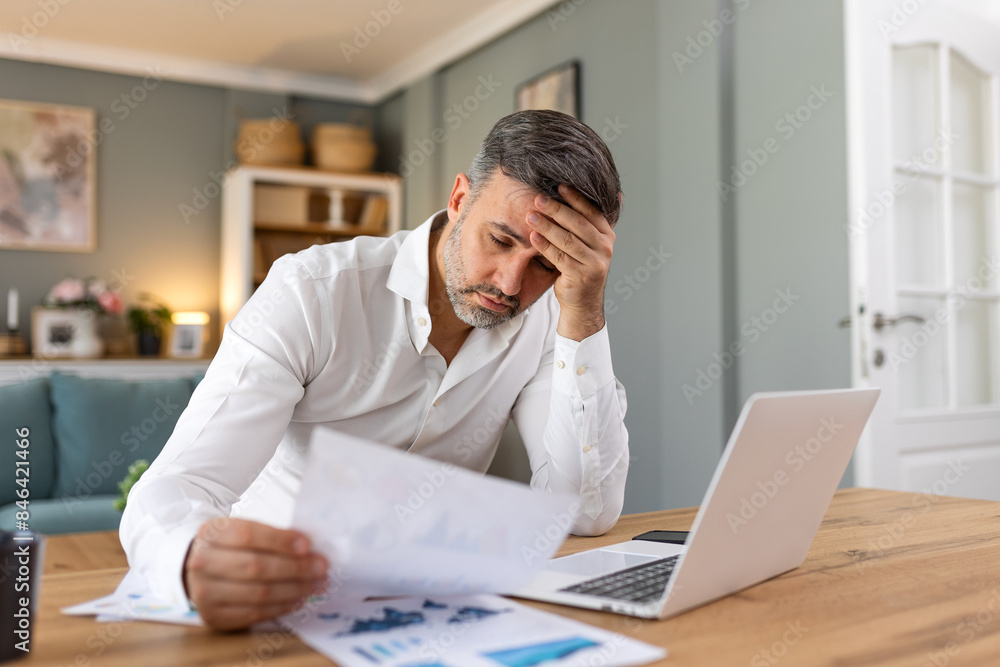 Handsome man freelancer noting information for planning project doing remote job via laptop computer. Man reading email on modern laptop device . Handsome man freelancer noting information for planning project doing remote job via laptop computer. Man reading email on modern laptop device .
