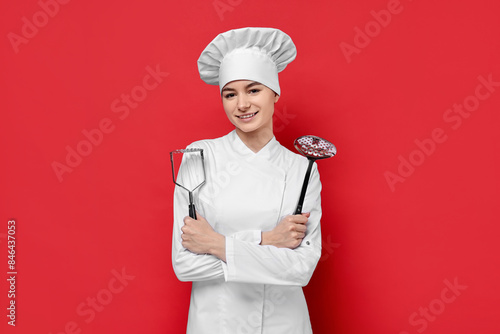 Billede på lærred Professional chef with potato pusher and skimmer on red background