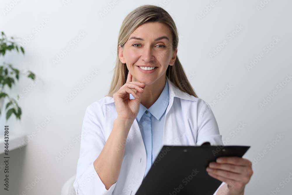 Portrait of happy doctor with clipboard in hospital Portrait of happy doctor with clipboard in hospital