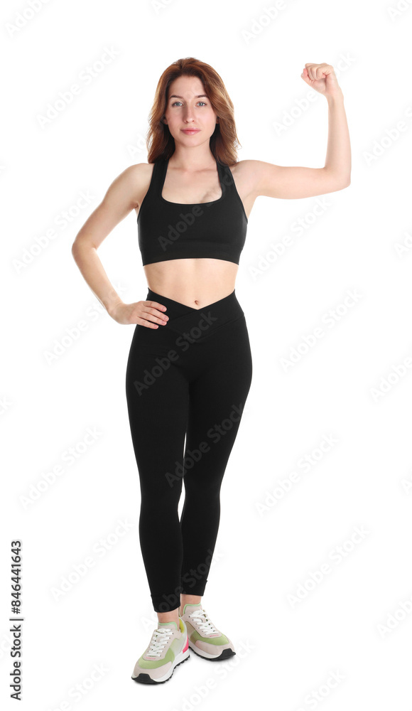 Woman with slim body showing muscles on white background Woman with slim body showing muscles on white background