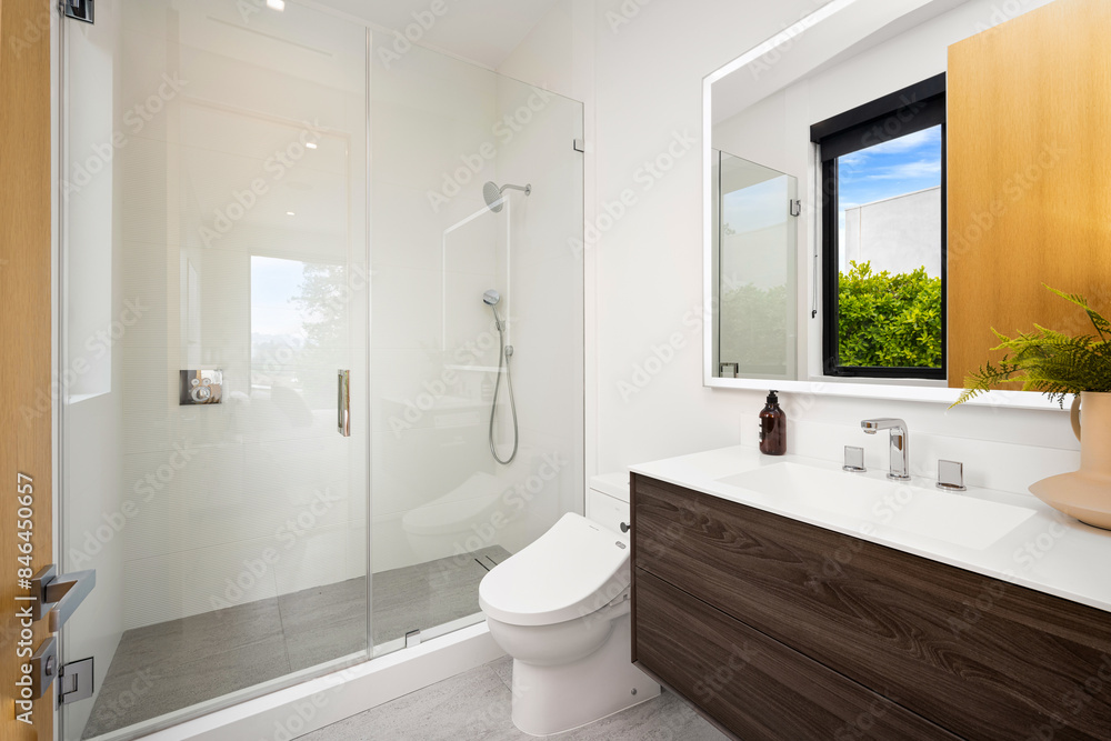 Bathroom with a wooden cabinet and white fixtures Bathroom with a wooden cabinet and white fixtures