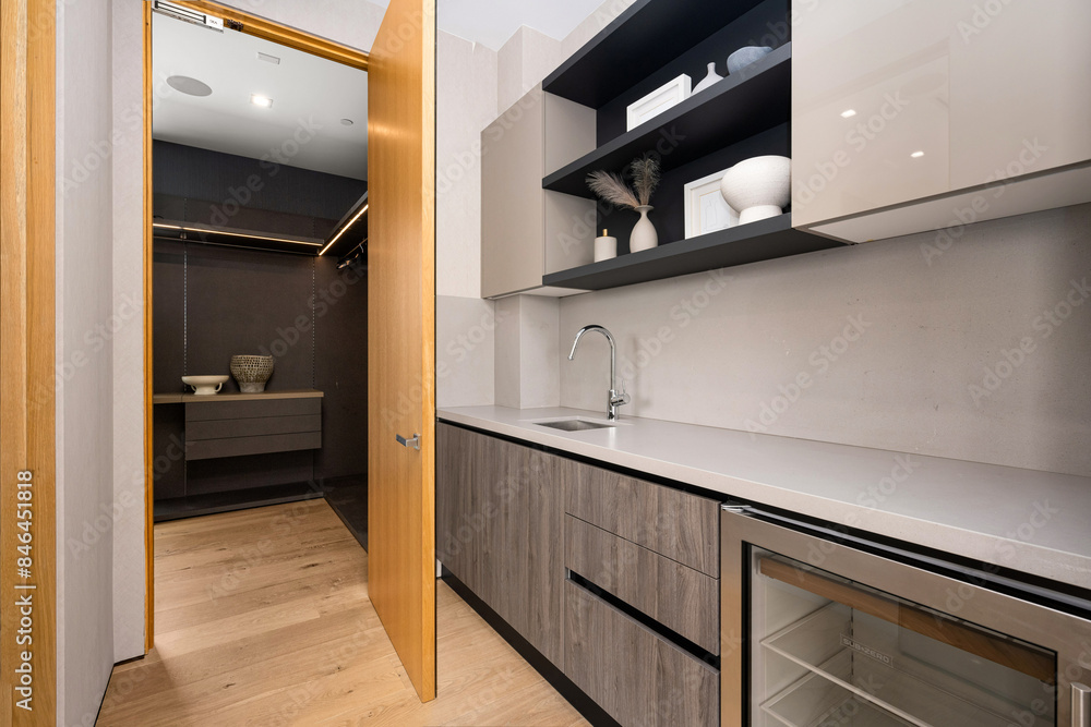 Kitchen interior with shelves and a door leading to another room Kitchen interior with shelves and a door leading to another room
