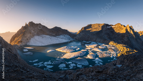 Summer landscape view of the Chuebodengletscher with icebergs lit by the rising sun photo
