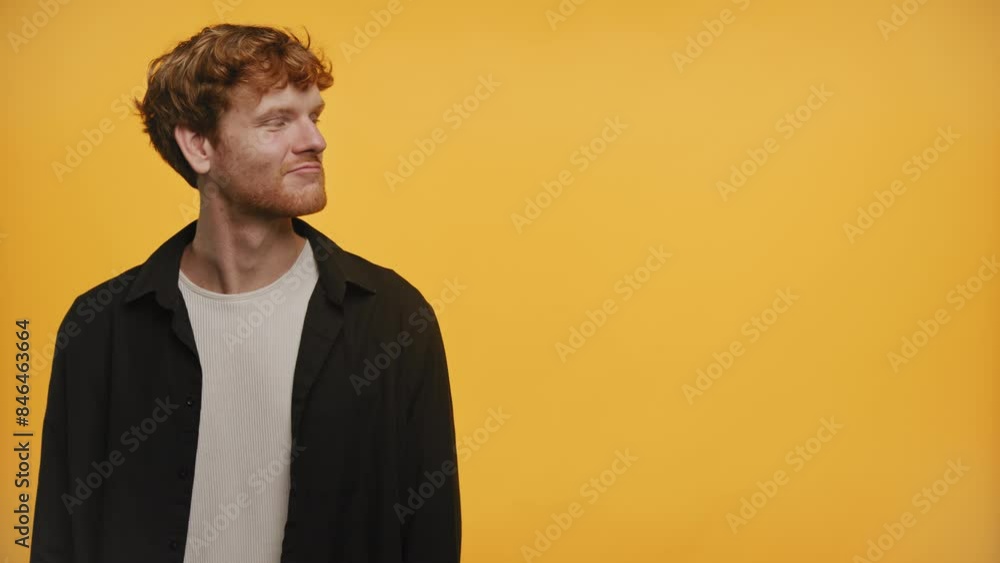 Happy man pointing in both directions on yellow background Happy man pointing in both directions on yellow background