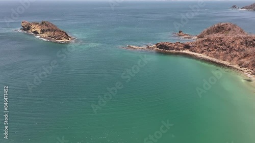 Drone view over the Pacific Ocean showcasing El Jobo beach with cliffs in Guanacaste, Costa Rica photo