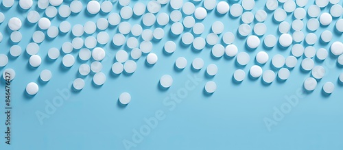 Copy space image of water softener tablets placed on a light blue background arranged in a flat lay style with enough empty space for adding text photo