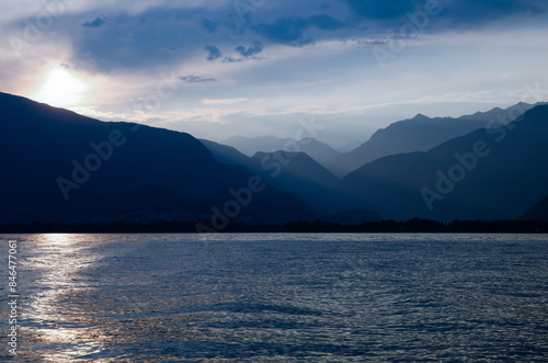 Beautiful Sunset over an Alpine Lake Maggiore with Mountain Range and Sky in Ticino, Switzerland.