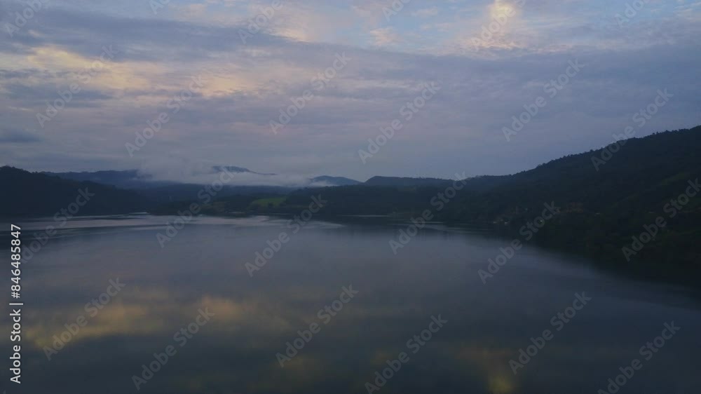 Sunset, a drone captures the Blue Lagoon in Tarapoto, Peru, encircled by boundless forests and hills