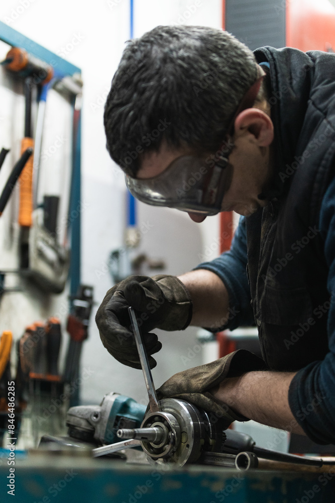 Mechanic working at workshop bench Mechanic working at workshop bench