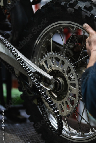 mechanic fixing motocycle wheel © Frenchiebuddha