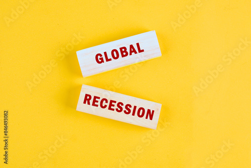 Worlds GLOBAL RECESSION a conceptual phrase on wooden blocks lying on a beautiful uniform tone