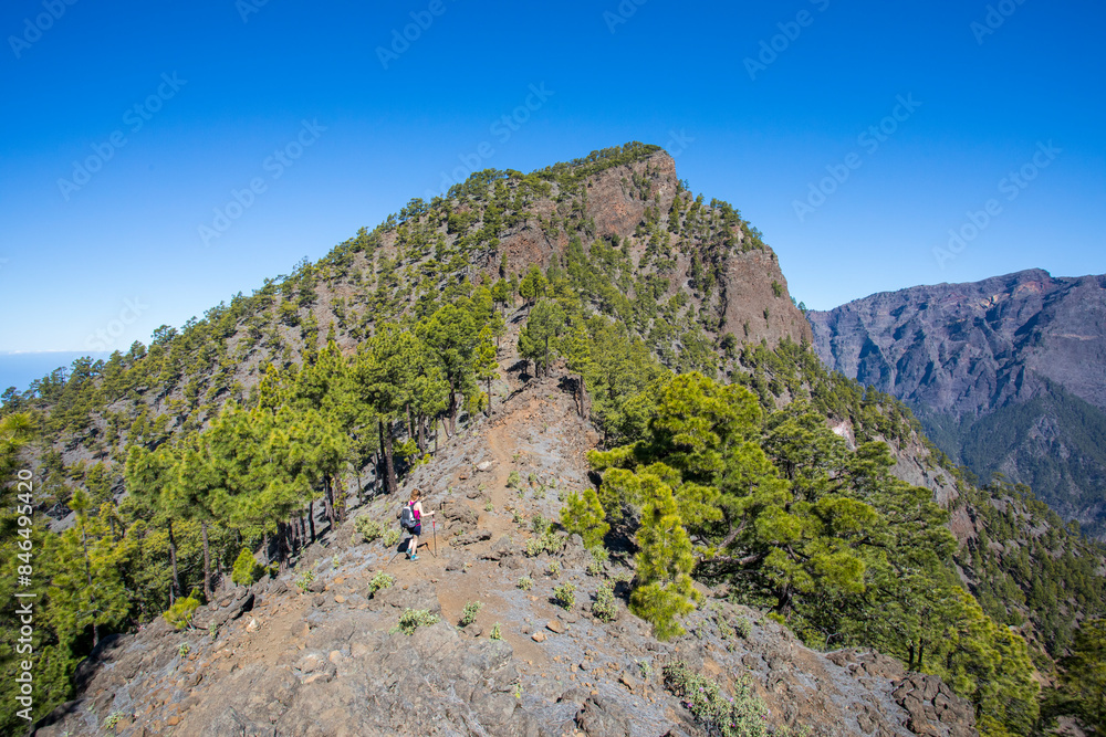 Young woman summit to Bejenado Peak in Caldera de Taburiente, La Palma, Spain Young woman summit to Bejenado Peak in Caldera de Taburiente, La Palma, Spain