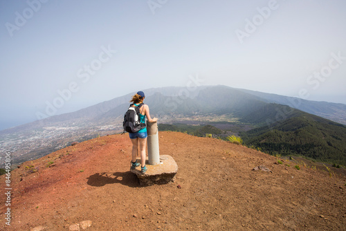 A young woman walking towards Birigoyo peak, La Palma Island, Canary Islands. photo