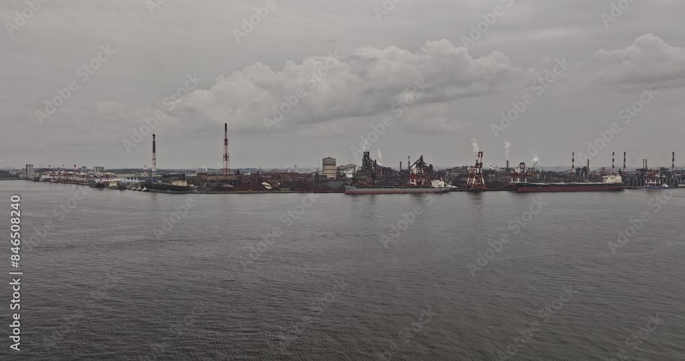 Nagoya Japan Aerial v1 flyover captures industrial port harbor with ships docked at the shore of Steel Furnace Plant in Tokaimachi on a gloomy overcast day - Shot with Mavic 3 Pro Cine - October 2023 Nagoya Japan Aerial v1 flyover captures industrial port harbor with ships docked at the shore of Steel Furnace Plant in Tokaimachi on a gloomy overcast day - Shot with Mavic 3 Pro Cine - October 2023