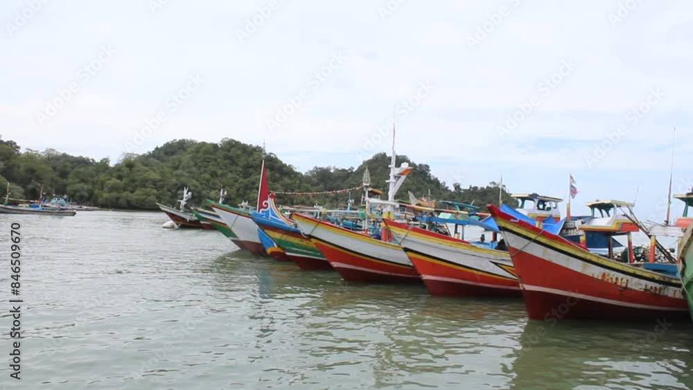 Traditional fishing boats are docked at Sendang Biru Pier where the place is a Consumption marine fish auction in Malang, Indonesia Traditional fishing boats are docked at Sendang Biru Pier where the place is a Consumption marine fish auction in Malang, Indonesia