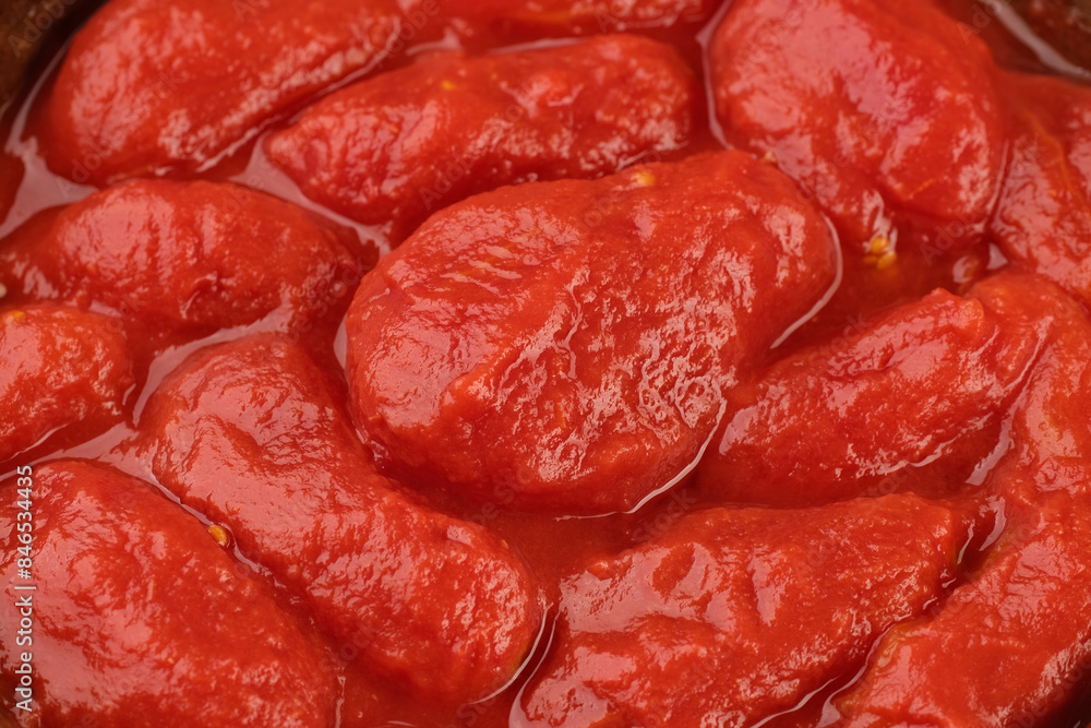Whole peeled tomatoes, covered with tomato juice. Italian food ingredient Whole peeled tomatoes, covered with tomato juice. Italian food ingredient