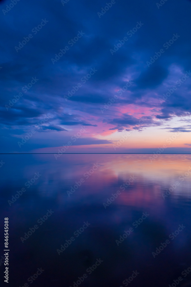 Stunning sunset over a tranquil ocean, reflecting vibrant clouds and calm waters, evoking peace and serenity. Stunning sunset over a tranquil ocean, reflecting vibrant clouds and calm waters, evoking peace and serenity.