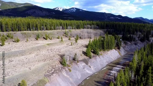 Small river flowing with trees beside it