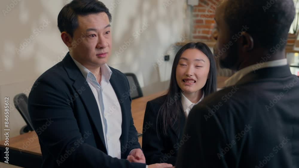 Three multiracial business people in office teamwork meeting Asian man ...