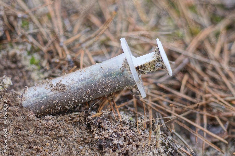 one white syringe lying on the ground in the street one white syringe lying on the ground in the street