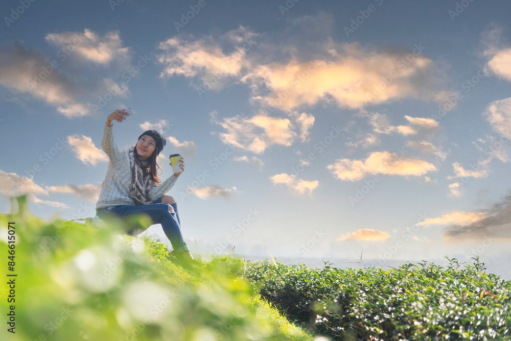 Woman drinking coffee in sun sitting outdoor in sunshine light enjoying her morning coffee Woman drinking coffee in sun sitting outdoor in sunshine light enjoying her morning coffee