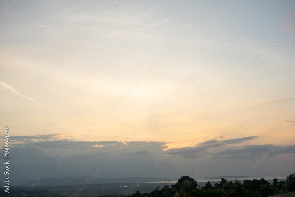 a view of the sunset over the water and trees a view of the sunset over the water and trees