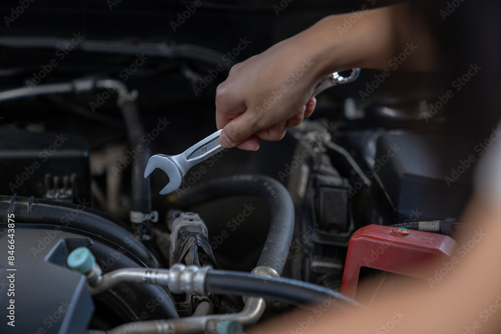 A woman checks the engine condition before setting off on a journey A woman checks the engine condition before setting off on a journey