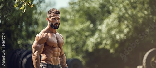 Muscular man in a park doin...