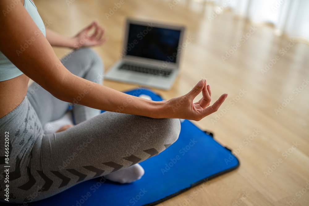 Fototapeta premium Portrait of beautiful sportswoman, fitness girl watching videos on laptop during workout