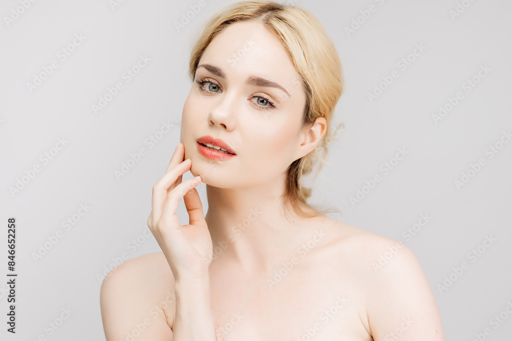 Close-up portrait of a charming half-naked woman in the studio. Portrait of a charming, sensual blonde on a light background. Cosmetology concept. Close-up portrait of a charming half-naked woman in the studio. Portrait of a charming, sensual blonde on a light background. Cosmetology concept.