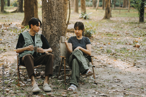 Asian couple sweet in tent inside on they camping trip, traveller relax and sleep togather in out door and camping trip