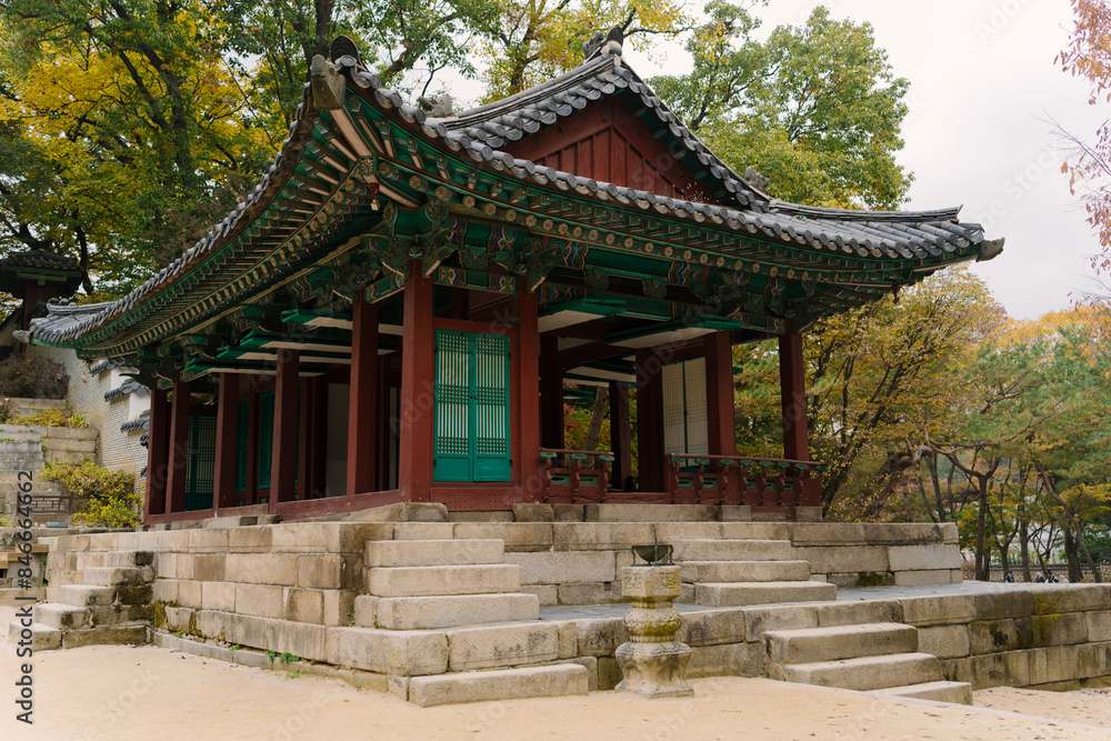 a traditional Korean pavilion with a tiled roof and green window details, set amidst lush trees in Changdeokgung Palace’s Biwon Garden, Seoul. a traditional Korean pavilion with a tiled roof and green window details, set amidst lush trees in Changdeokgung Palace’s Biwon Garden, Seoul.