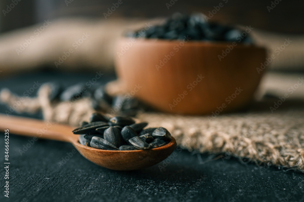 Sunflower seeds in wooden bowl on a rural background Sunflower seeds in wooden bowl on a rural background