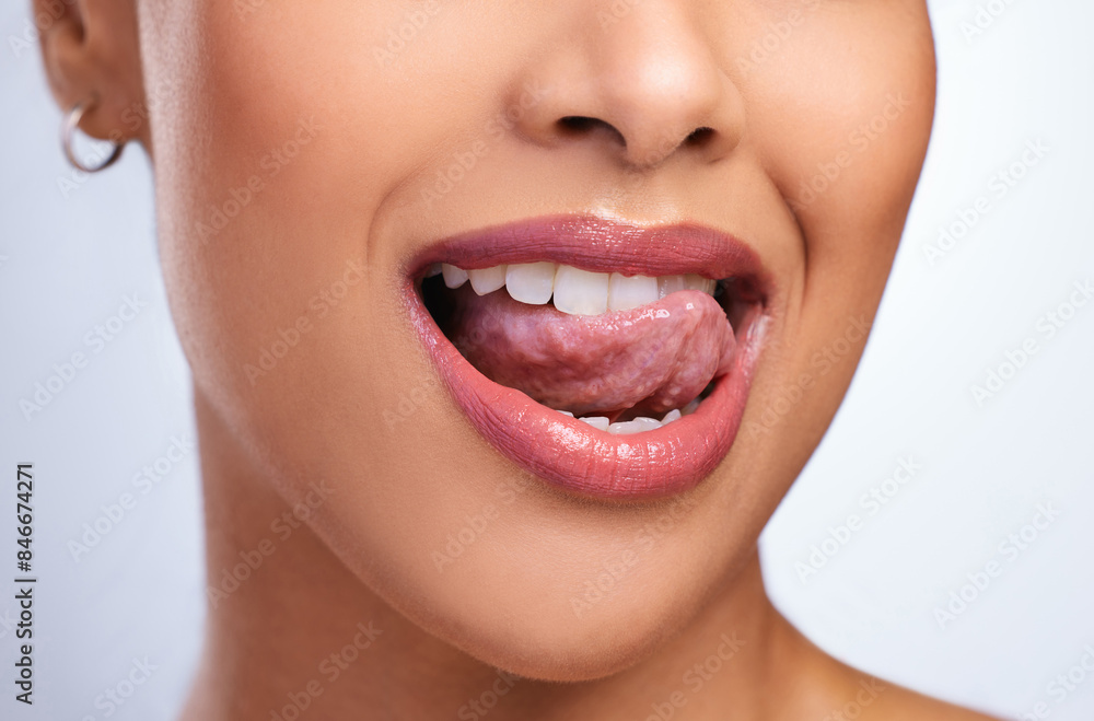 Fototapeta premium Woman, teeth and tongue with lipstick and mouth for dental care, hygiene and oral health. Model girl, cosmetics and happy for veneers in studio with glow, wellness and emoji for whitening or results