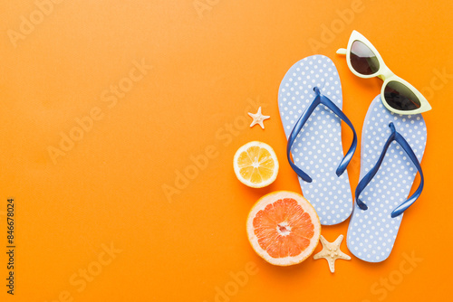 Top view composition of flip flops placed with beach accessories top view on table background. Tropical summer vacation concept Flat lay