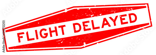 Grunge red flight delayed word hexagon rubber seal stamp on white background