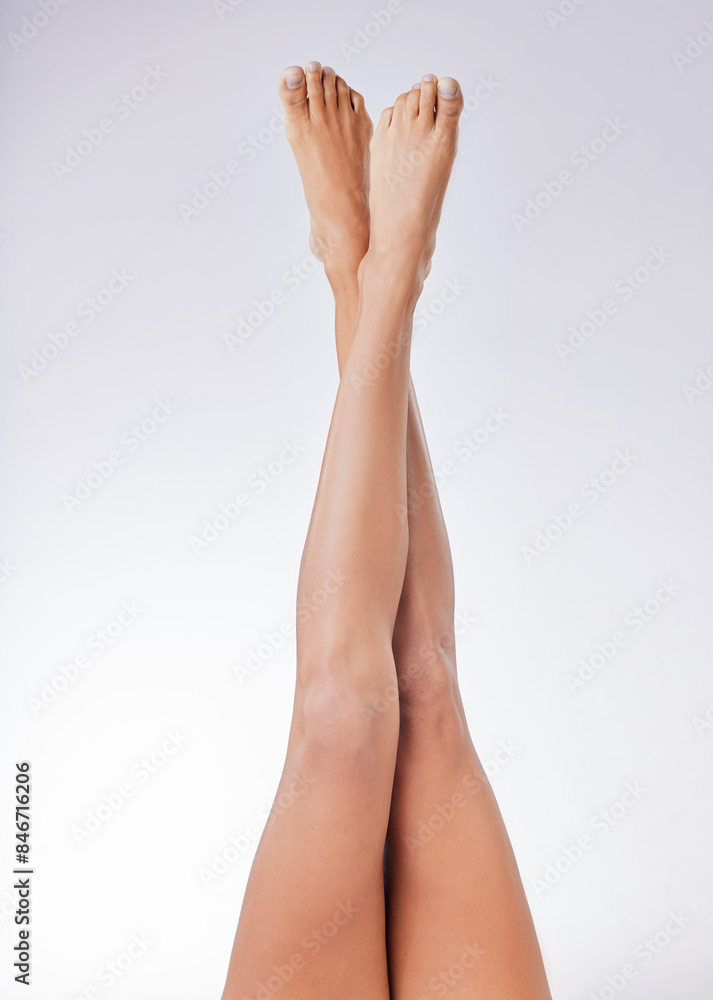 Woman, feet and legs smooth raised for cosmetics, skincare and epilation in white studio background. Female person, wax or clean shave relaxing for health, wellness and hygiene or hair removal Woman, feet and legs smooth raised for cosmetics, skincare and epilation in white studio background. Female person, wax or clean shave relaxing for health, wellness and hygiene or hair removal
