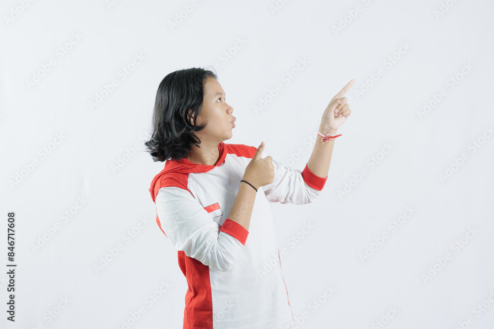 a young Indonesian woman raises her pointing finger with a big smile, the concept of Indonesia's independence day on August 17, isolated on a white background. a young Indonesian woman raises her pointing finger with a big smile, the concept of Indonesia's independence day on August 17, isolated on a white background.