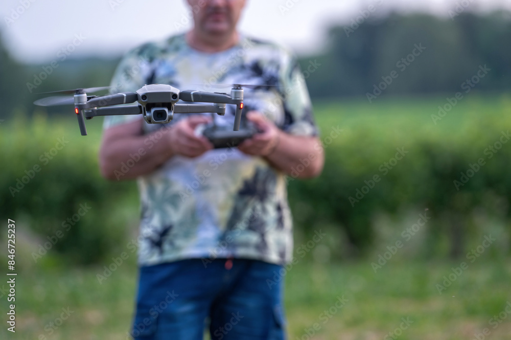 drone copter flying in the air with blurred man on background drone copter flying in the air with blurred man on background